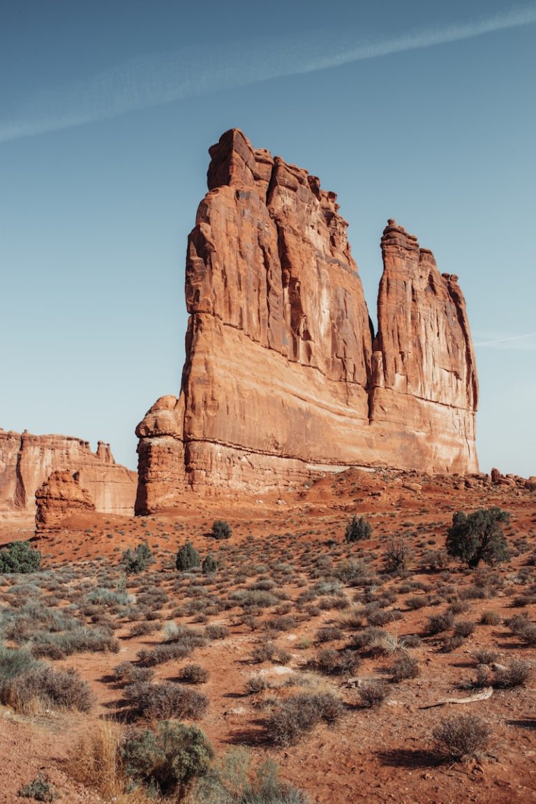 A large rock formation in the middle of a desert